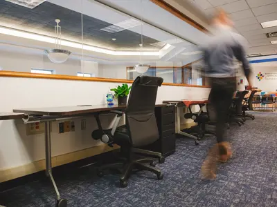 office desk with person walking by