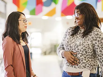 Two women having a conversation while standing