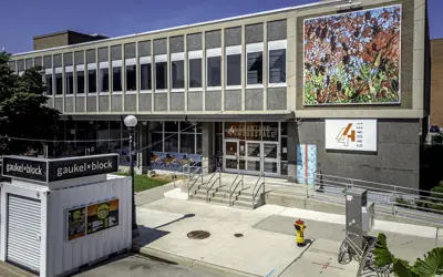 front of large building with colourful mural on front